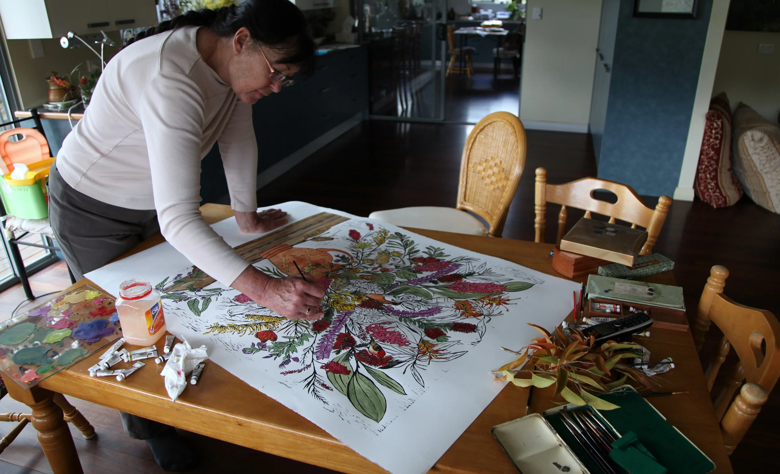  If I intend to add colour to the print, I have to wait a number of days for the black ink to dry. Then, using Winsor and Newton quality watercolour paints, I paint in between the black lines while referring to the actual colours in the flowers in th