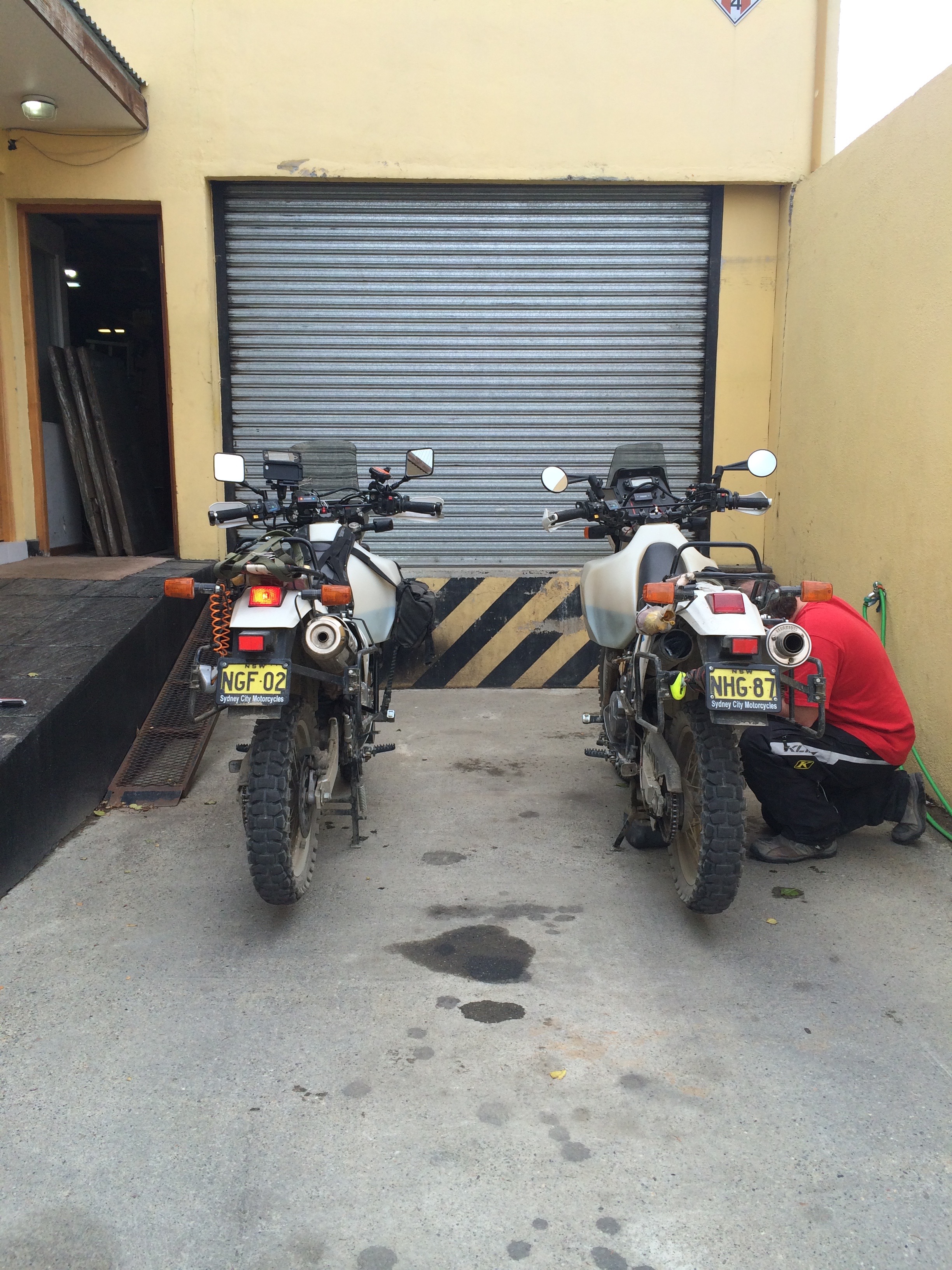 Changing oil at the back of the bike shop