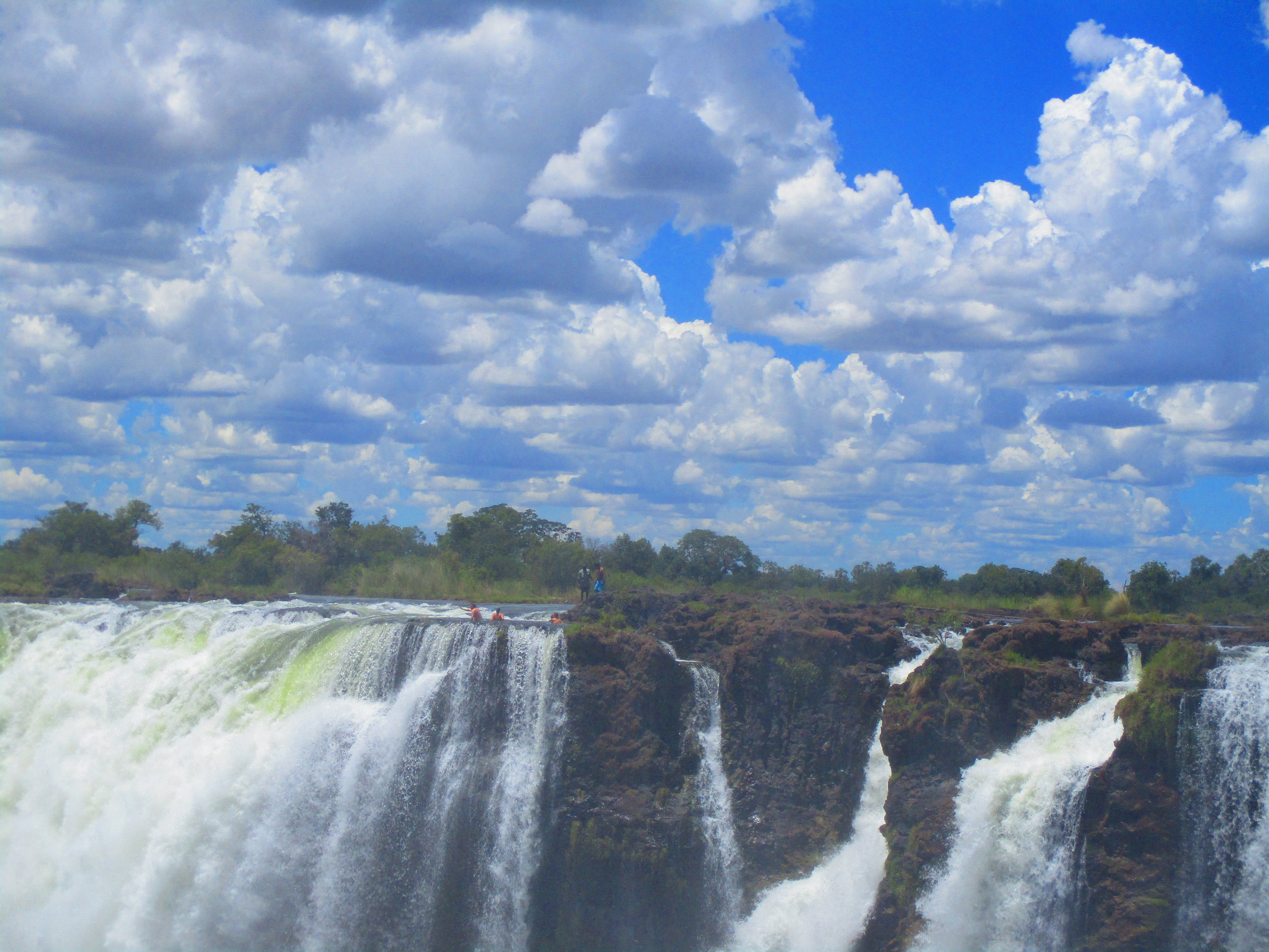 People in Devil's Pool at the top of the falls.