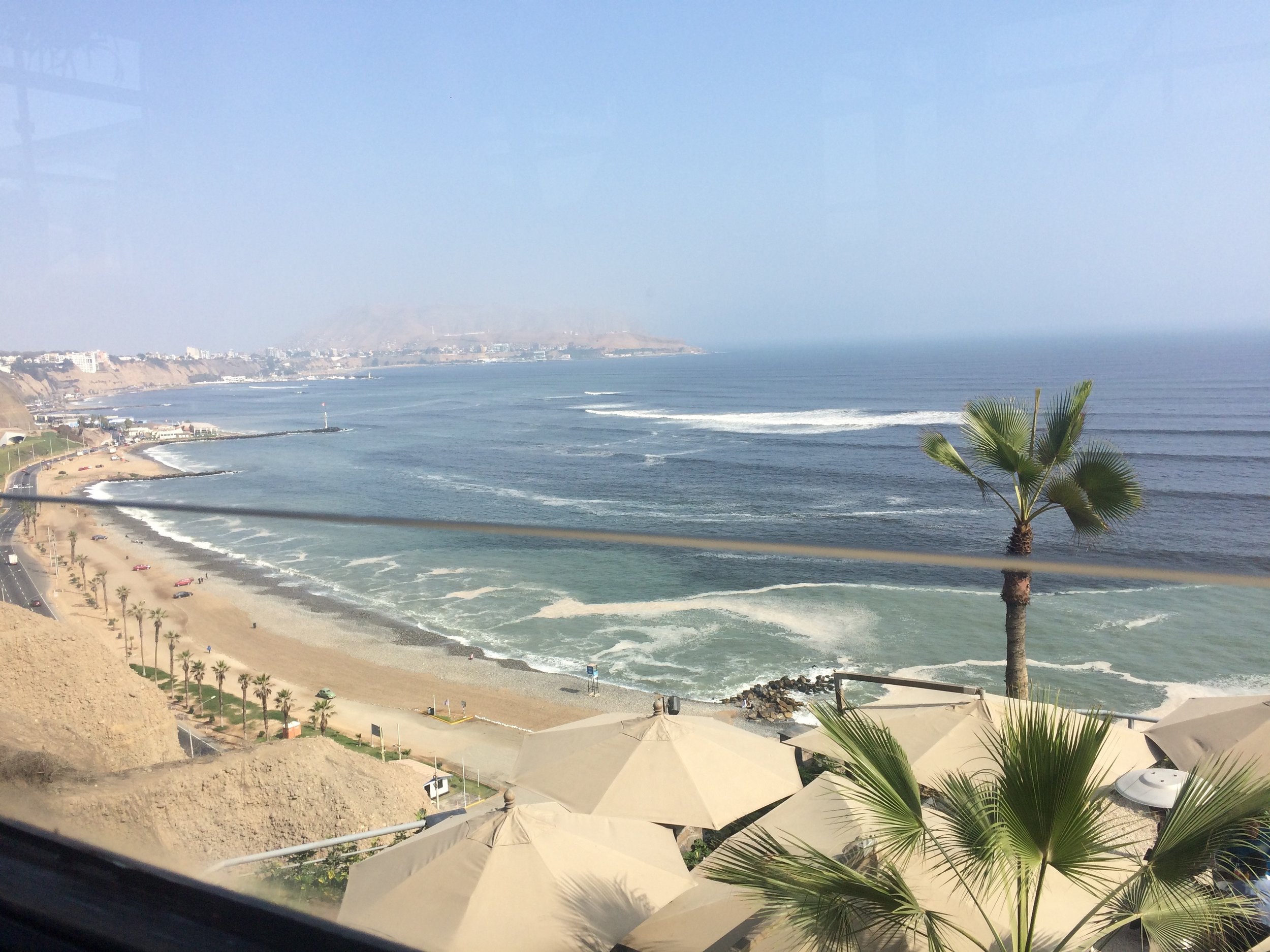 Unfortunately there's no nice restaurant to smooth over us trying to be cultured. But we make up for it when we get back and are dropped off at Larcomar. We start with a very good pisco sour with this great view.