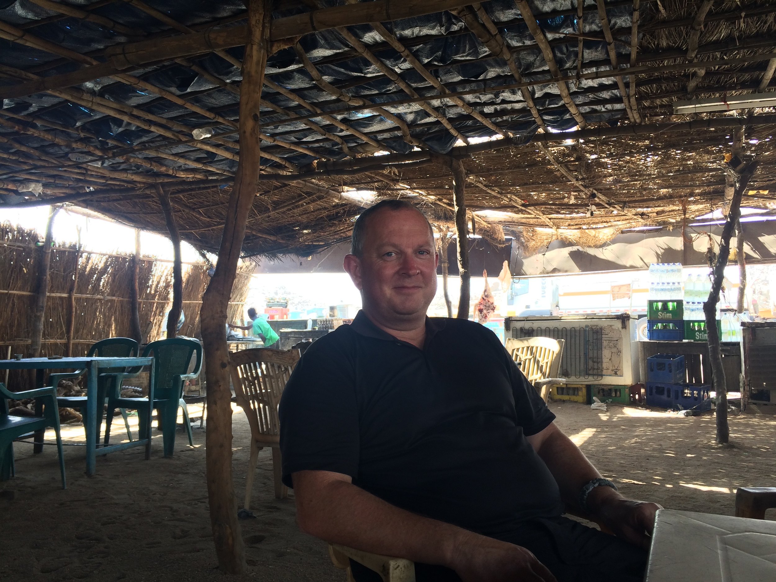 Road side cafe Sudan. Topping ourselves up with cold water.