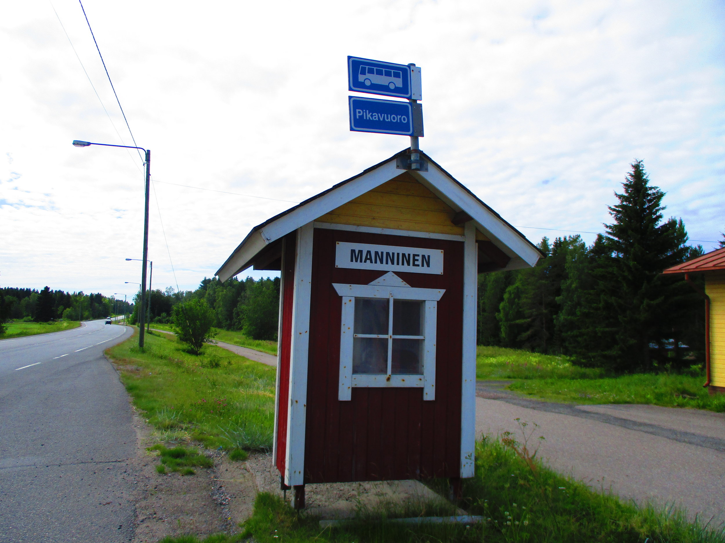 A bus stop through the countryside.