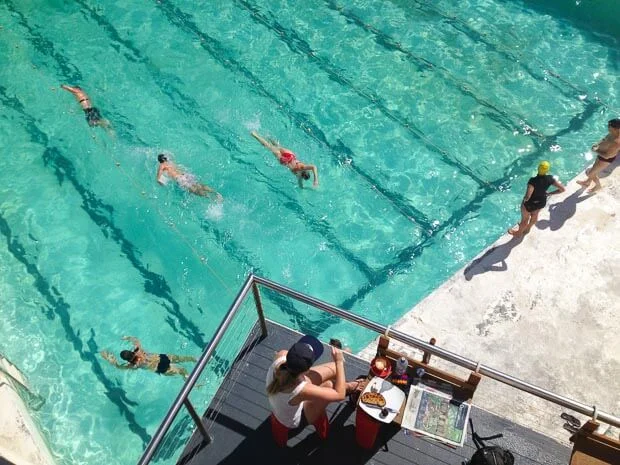 Woman Eating Breakfast At Icebergs Swimming Pool In Bondi Beach 