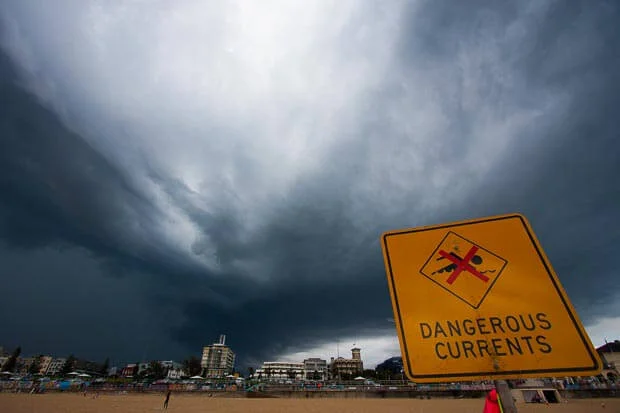 Landscape Photograph Of Storm Clouds Over Warning Sign At Bondi Beach