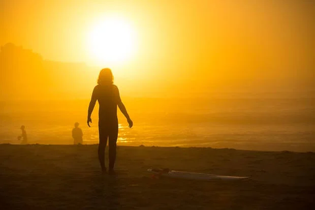 Surfer Stretching At Sunrise On Bondi Beach 