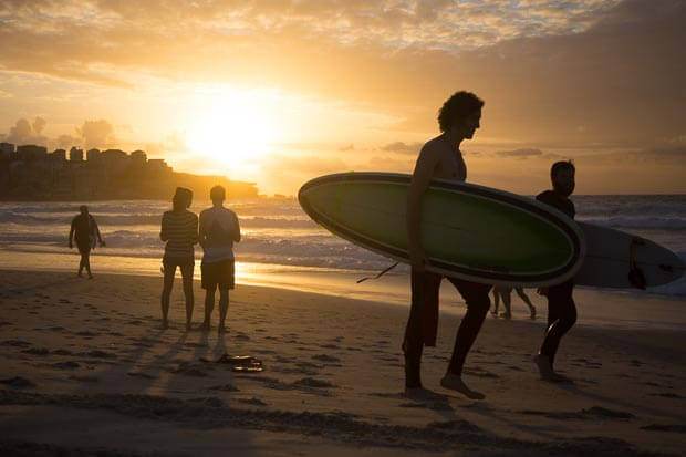 Landscape Photograph Of Sunrise At Bondi Beach With Surfers Walking Into Water