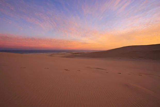 Golden Sunset Across The Red Sand Of Stockton Dunes In NSW 