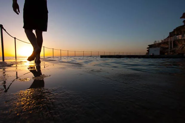 Swimmer Walking Into Bronte Ocean Pool At Sunrise With Reflections