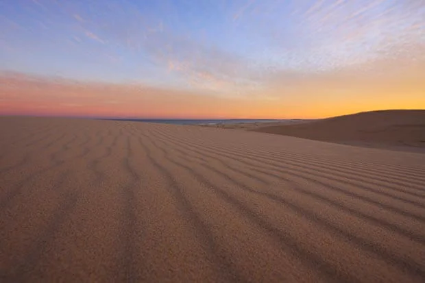 The Wind Leaves Marks In the Sand With A Bright Sunset At Stockton Dunes