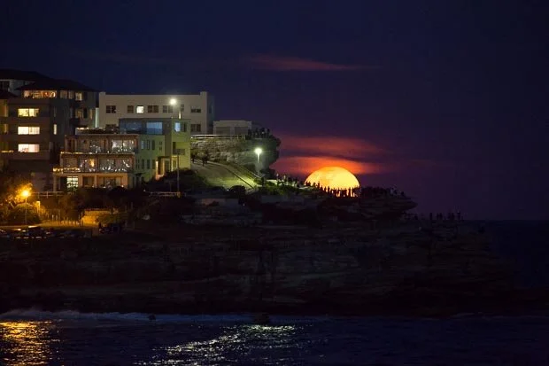 Huge Super Moon Rising Over Bondi Beach With Silhouette Of People