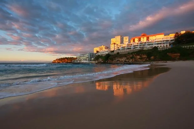 Pink Skies At Bondi Beach With Sunrise Reflection On Wet Sand