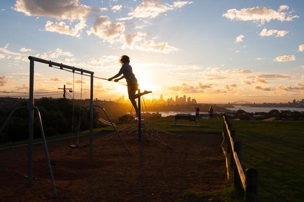 Woman on Swing With Her Silhouette Against Sydney Sunset