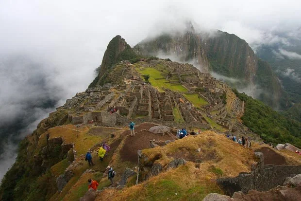 Low Grey Clouds Hover Above Machu Picchu In Peru
