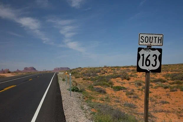 An Old Rusty Route 163 Road Sign Stands By the Highway In Utah 