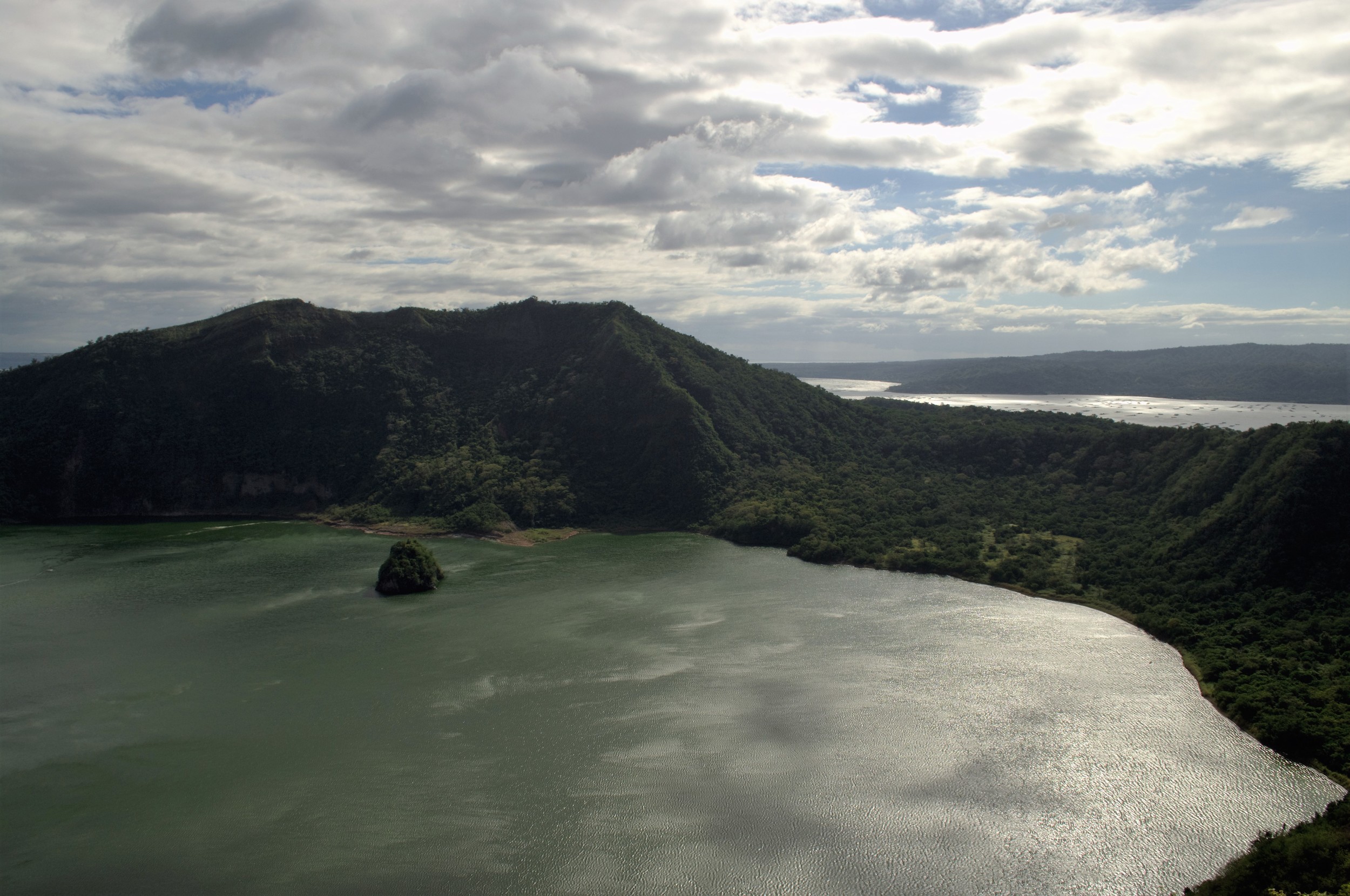 Shimmering crater lake with the volcanic outcrop
