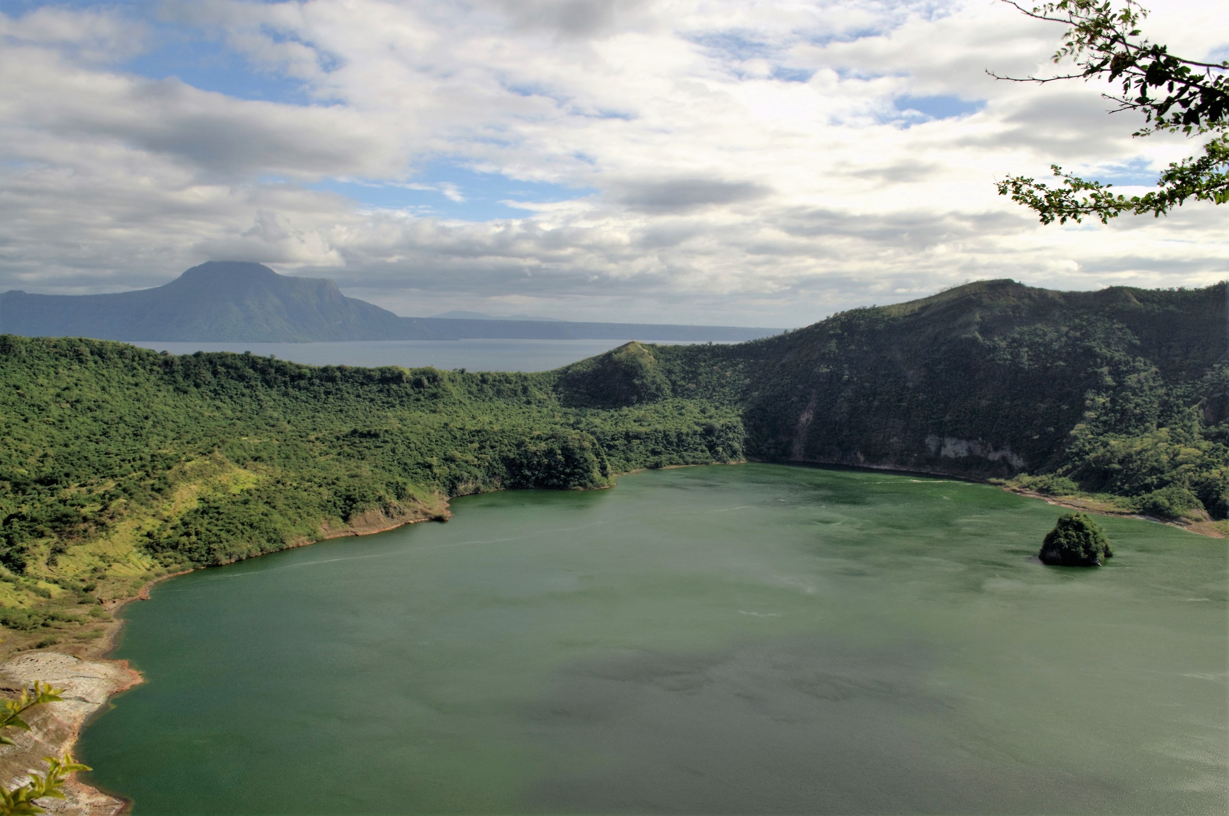 Shimmering crater lake with the volcanic outcrop
