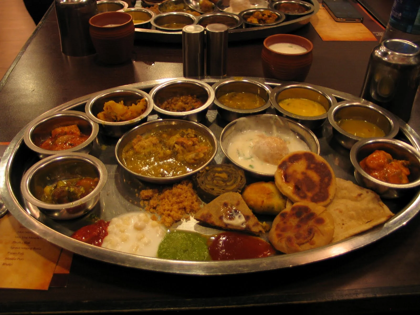 The famous Rajasthani thali. Courtesy: https://www.scoopwhoop.com/inothernews/indian-thalis/#.hkkg6lqzt
Normal
0
false
false
false
EN-IN
X-NONE
X-NONE
Normal
0
false
false
false
EN-IN
X-NONE
X-NONE
/* Style Definitions */
table.MsoNormalTable
{mso-style-name:"Table Normal";
mso-tstyle-rowband-size:0;
mso-tstyle-colband-size:0;
mso-style-noshow:yes;
mso-style-priority:99;
mso-style-qformat:yes;
mso-style-parent:"";
mso-padding-alt:0cm 5.4pt 0cm 5.4pt;
mso-para-margin-top:0cm;
mso-para-margin-right:0cm;
mso-para-margin-bottom:10.0pt;
mso-para-margin-left:0cm;
line-height:115%;
mso-pagination:widow-orphan;
font-size:11.0pt;
font-family:"Calibri","sans-serif";
mso-ascii-font-family:Calibri;
mso-ascii-theme-font:minor-latin;
mso-fareast-font-family:"Times New Roman";
mso-fareast-theme-font:minor-fareast;
mso-hansi-font-family:Calibri;
mso-hansi-theme-font:minor-latin;}