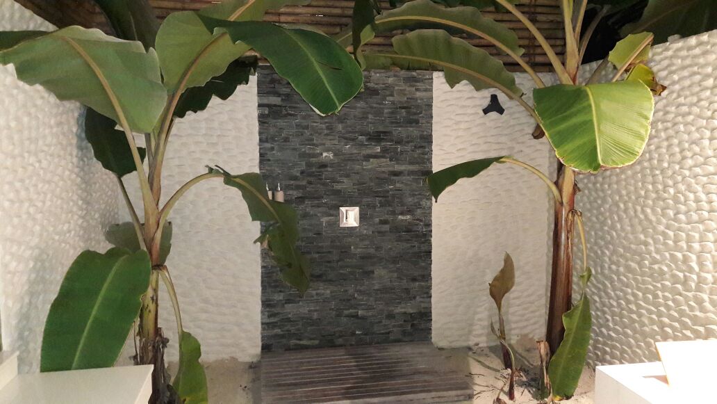 The shower area with Banana trees and sand floor
