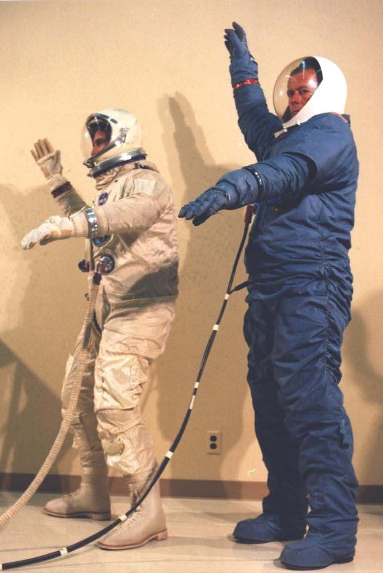 McDonnell-Douglas engineers demonstrating the reach and flexibility of the the David Clark G4C and Hamilton Standard MH-5 space suits. ( NRO MOL photograph 18 . Credit: NRO and McDonnell-Douglas).