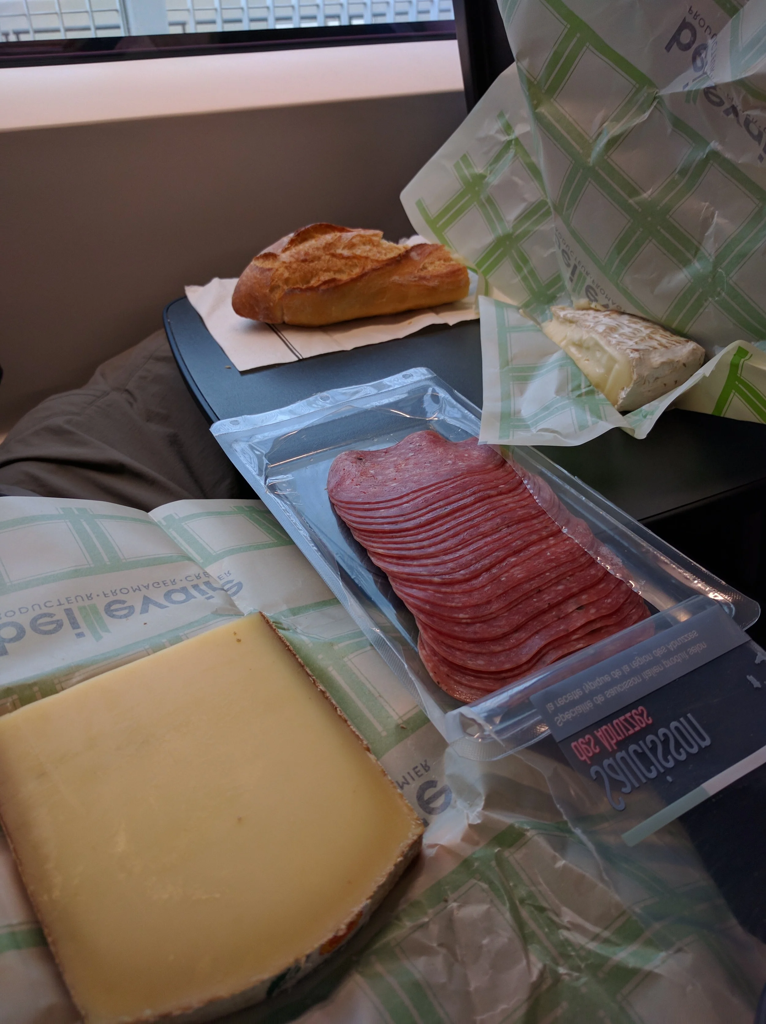 We took some of France with us on the train ride back to London. I had Jeff a little nervous because right before we were supposed to be at the train station we walked a few blocks in search of a Fromagerie (cheese shop). At the shop we bought some brie de melun and comté to go with our French baguette and salami. Yum!