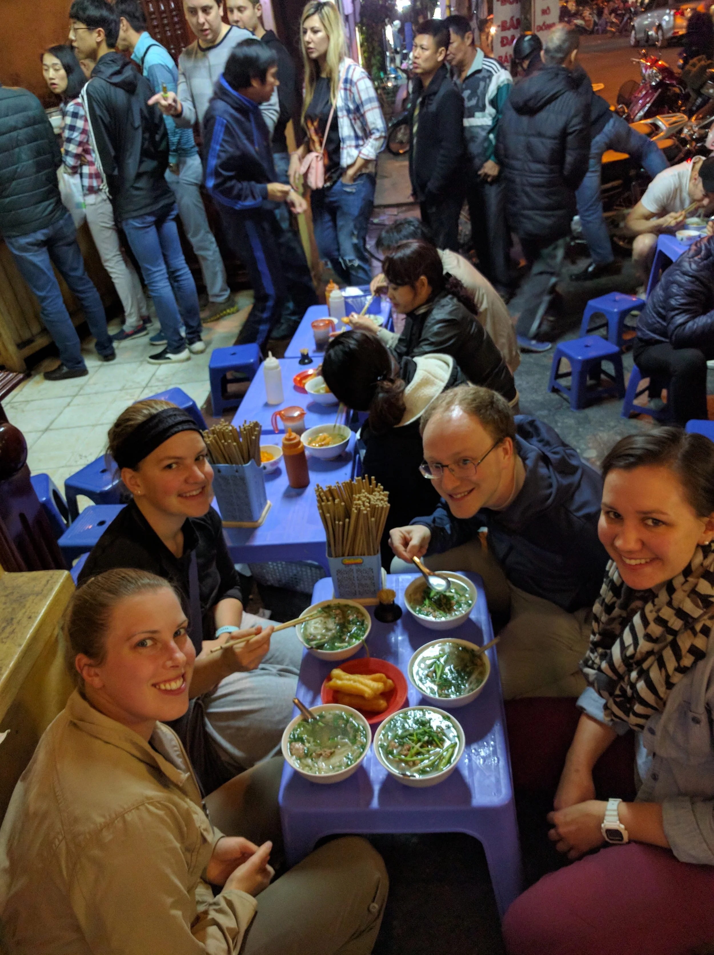For the most part, everywhere we went, we ate outside on tiny stools. It was like eating every meal at the kids table- good fun! Here we are eating pho in Hanoi.