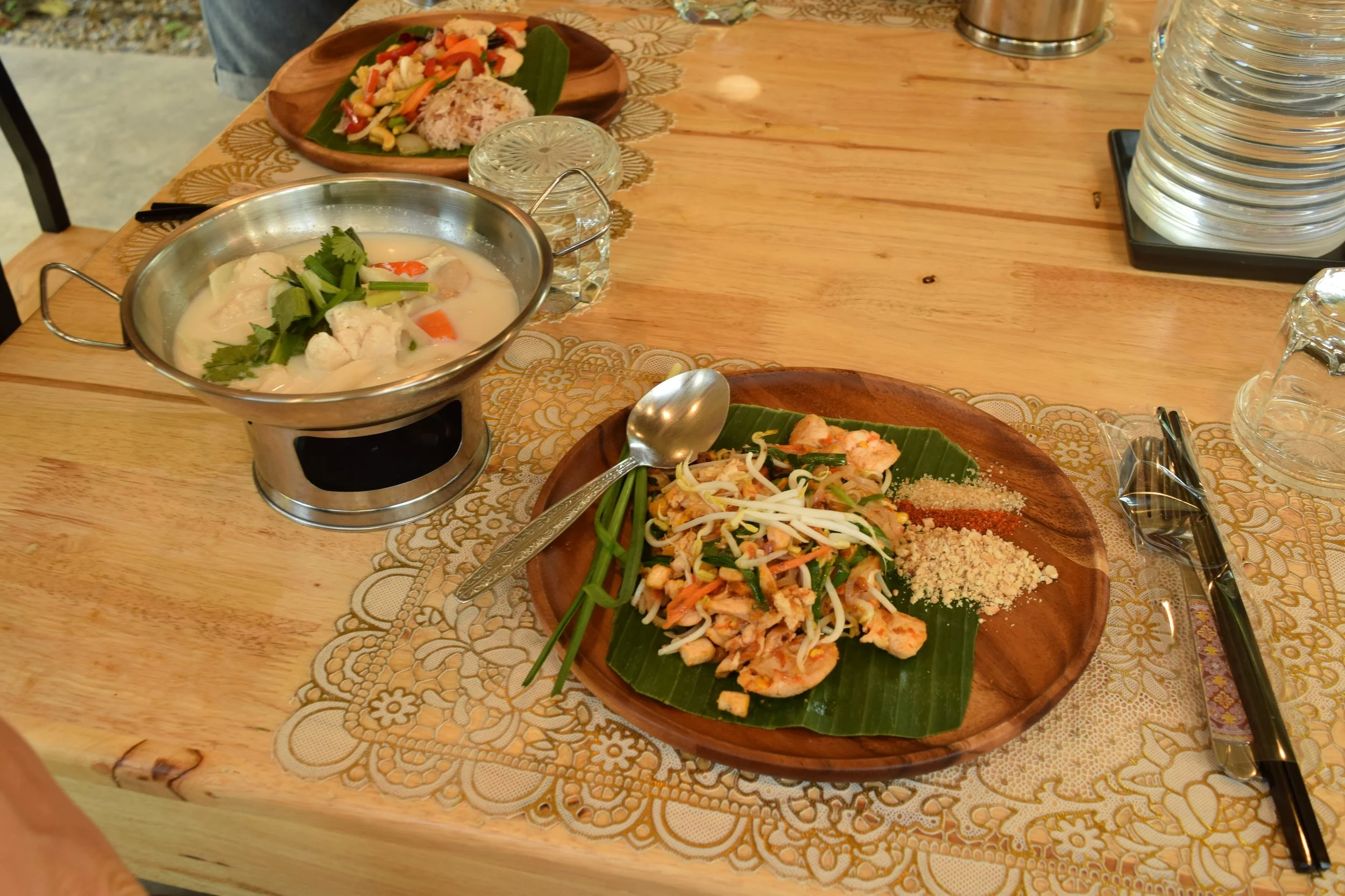 Course 1: My chicken pad thai (on plate), and coconut soup with chicken