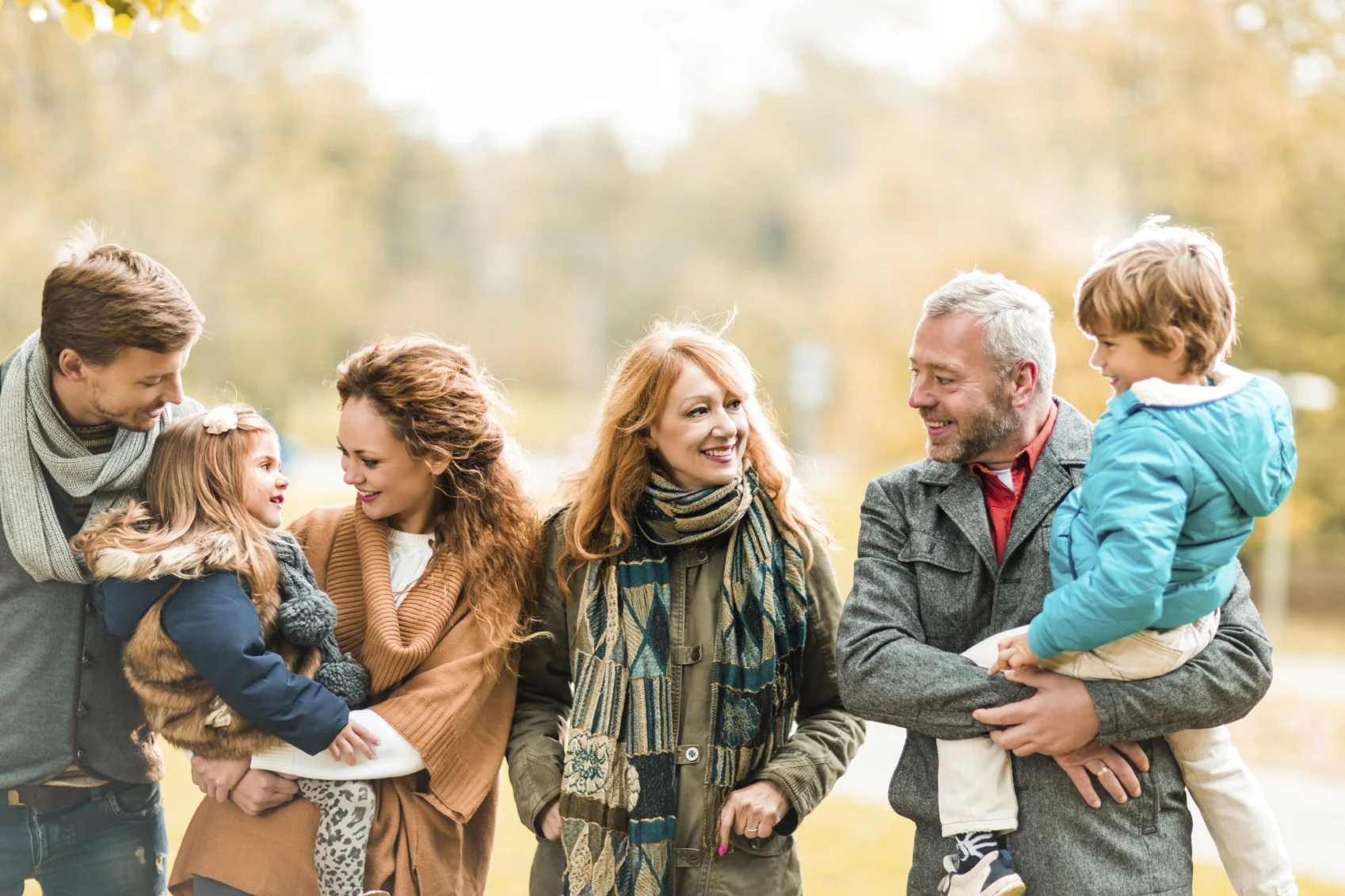 Group of four happy adults and two children