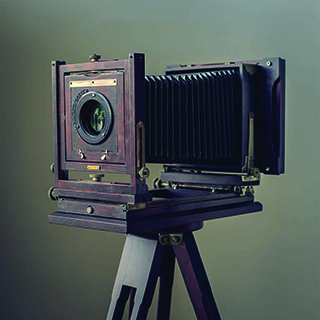This is Belle. She was born in 1901, and is ready to shoot again! We even made a custom wooden tripod to match. She's perfect at any event - corporate or wedding. 