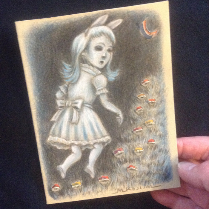 The finished color pencil drawing of the ghost bunny girl with the flaps revealing an orange moon and flame-colored flowers.