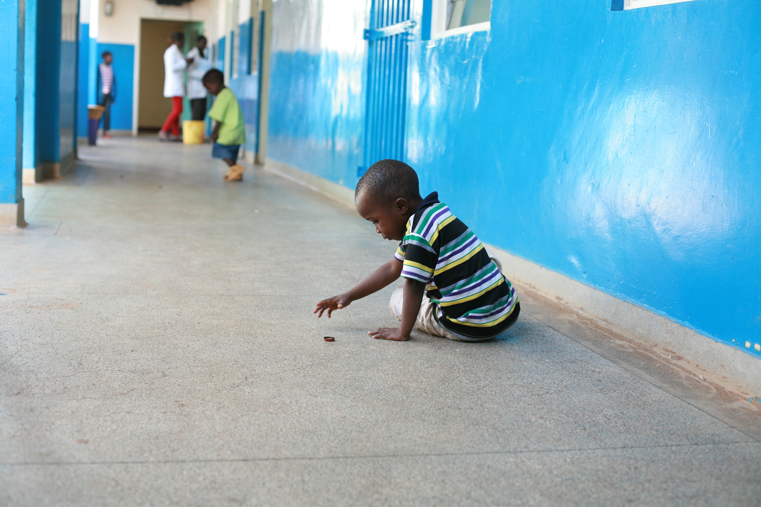 A child playing on one of  the corridors of ward 8. He is one of the children the hospital keeps in the facility because the parents havent paid for the medical bill..JPG