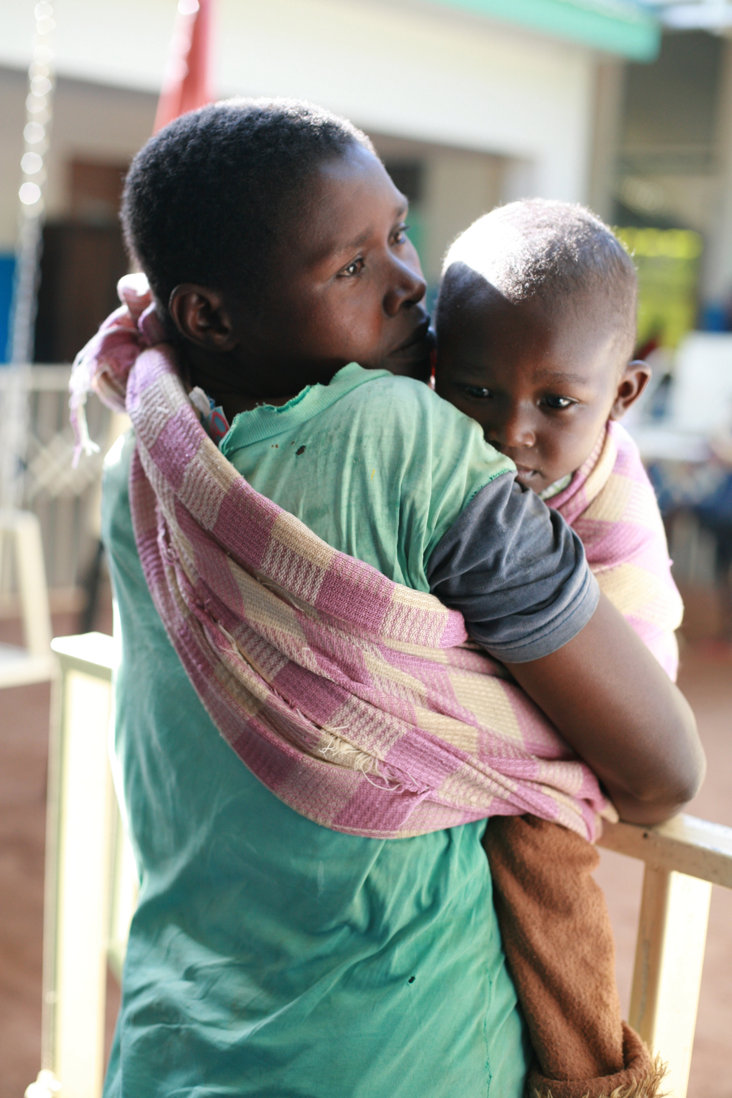 A mother comforts her son as they wait for the doctors to set up for his treatment.JPG