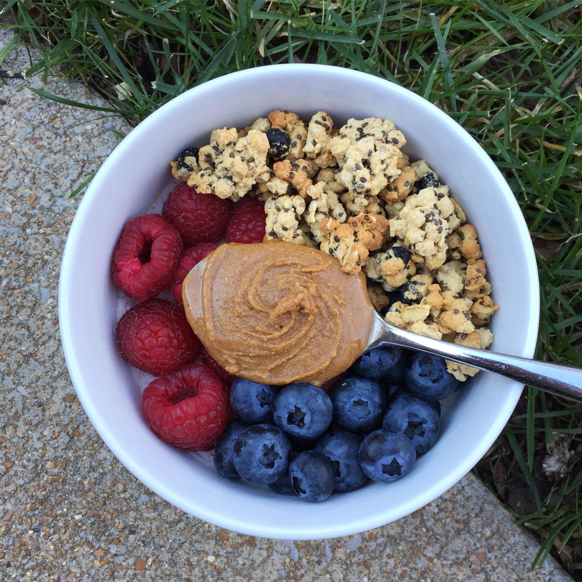 The granola on top is Mamma Chia wild blueberry clusters granola. The nut butter is Wild Friends Sugar Cookie Peanut Butter.