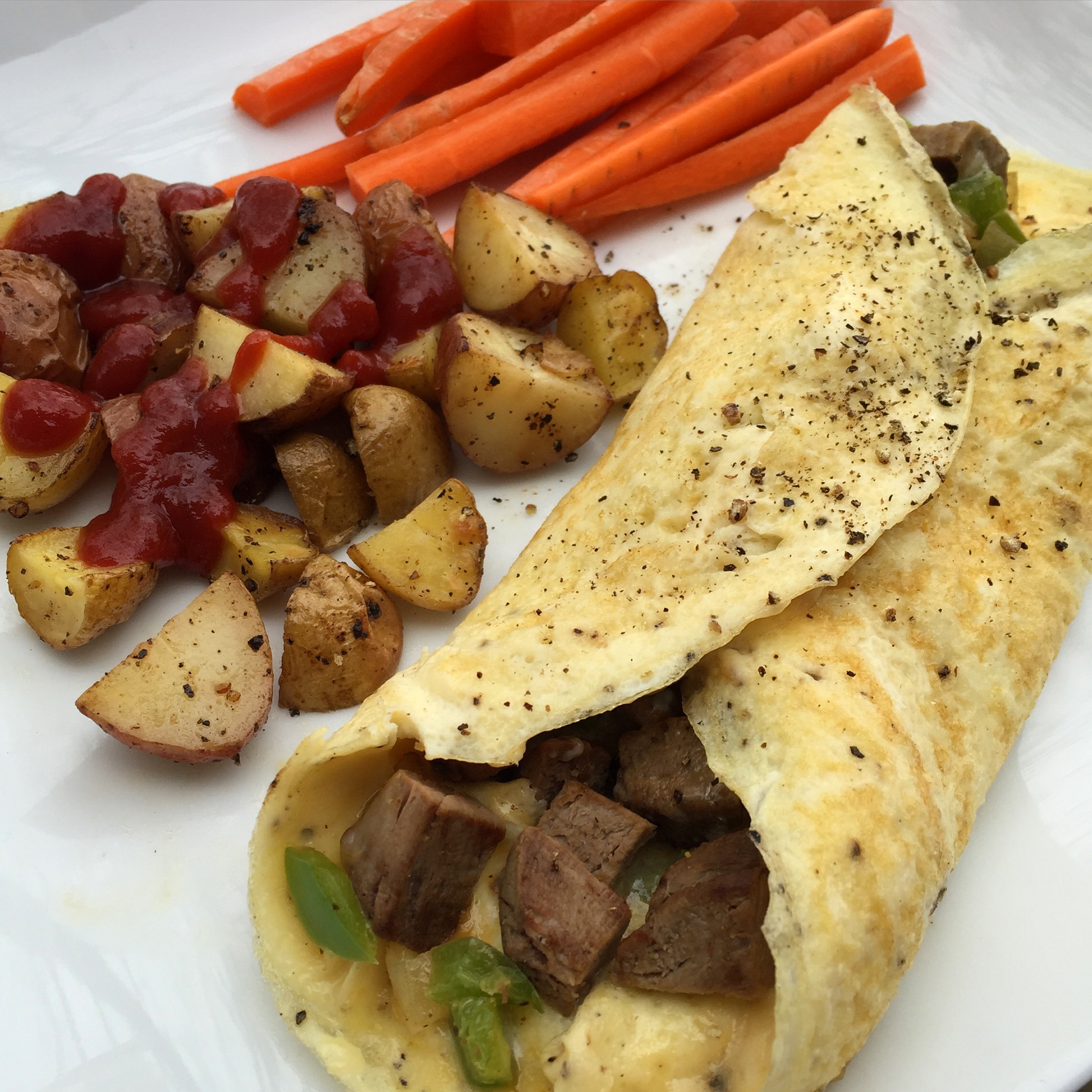 Omelet filled with leftover beef tenderloin, sautéed onions and green bell pepper, and lots of cheese.