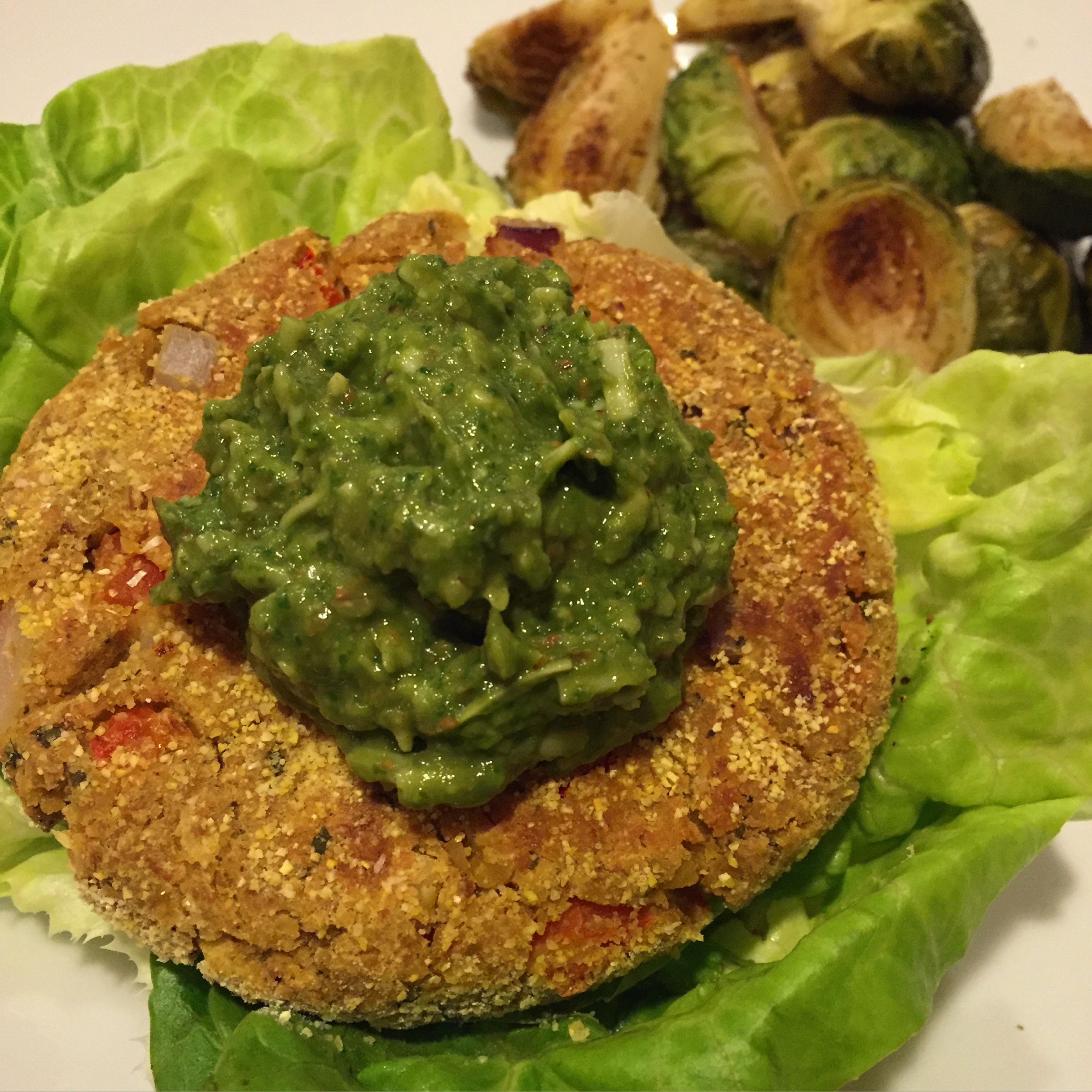 Chickpea-bean veggie burger + creamy avocado basil pesto + lettuce 'buns' + roasted brussel sprouts