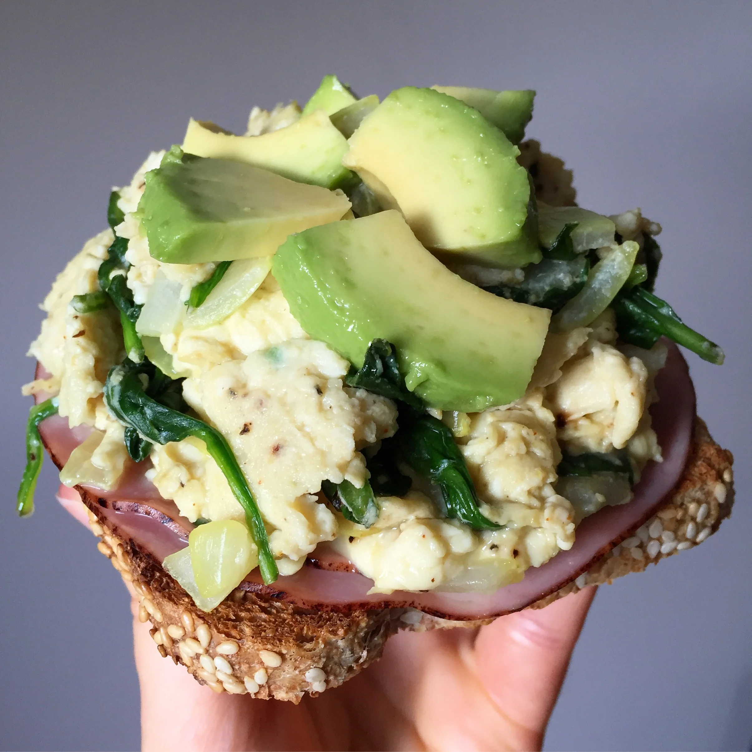 Toasted Sesame Food for Life Ezekiel bread + ham + scrambled eggs with spinach and onions + avocado + salt/pepper