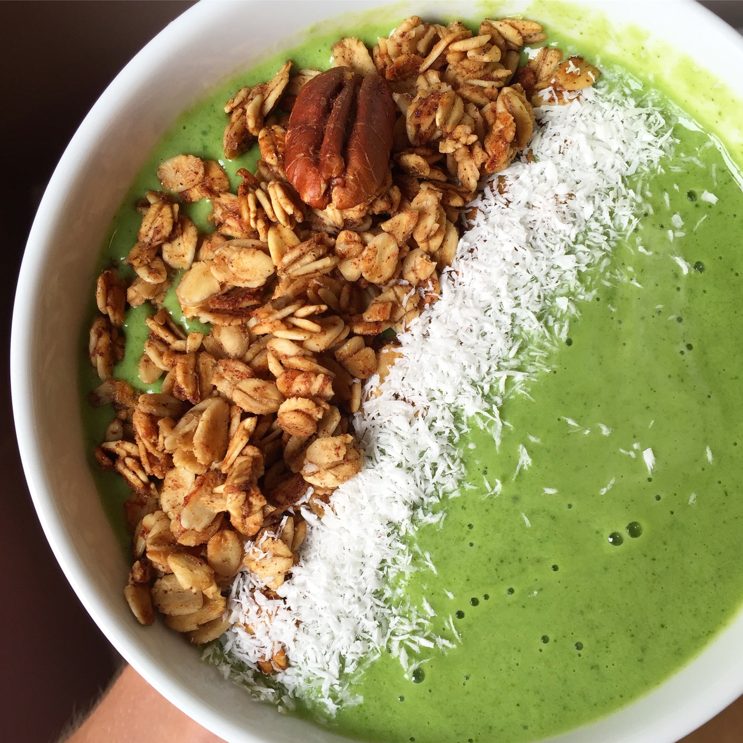 Banana Piña Colada Smoothie topped with coconut shreds and banana bread granola