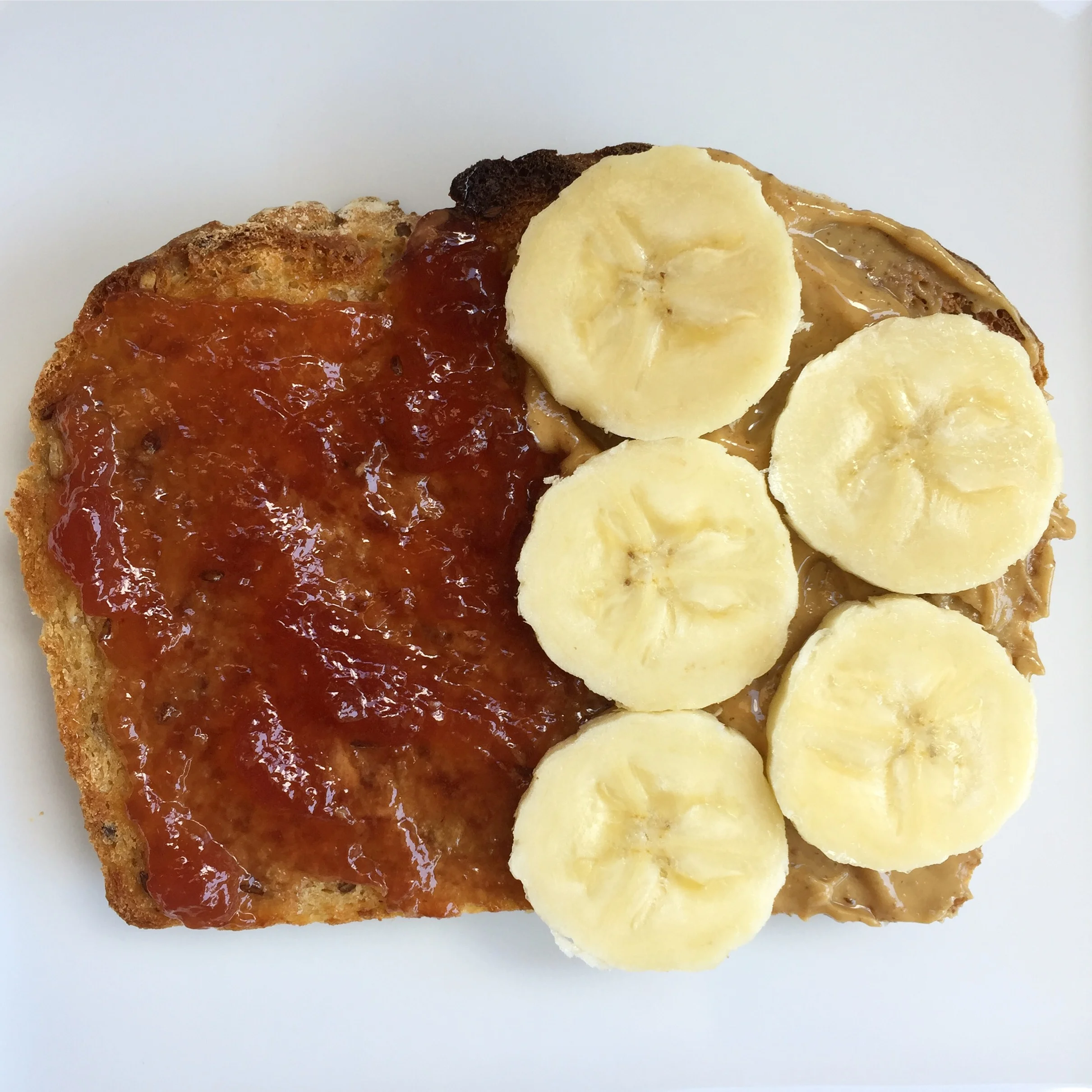 Homemade whole wheat bread ...1/2 with butter and strawberry jelly + 1/2 with crunchy Peanut Butter and banana
