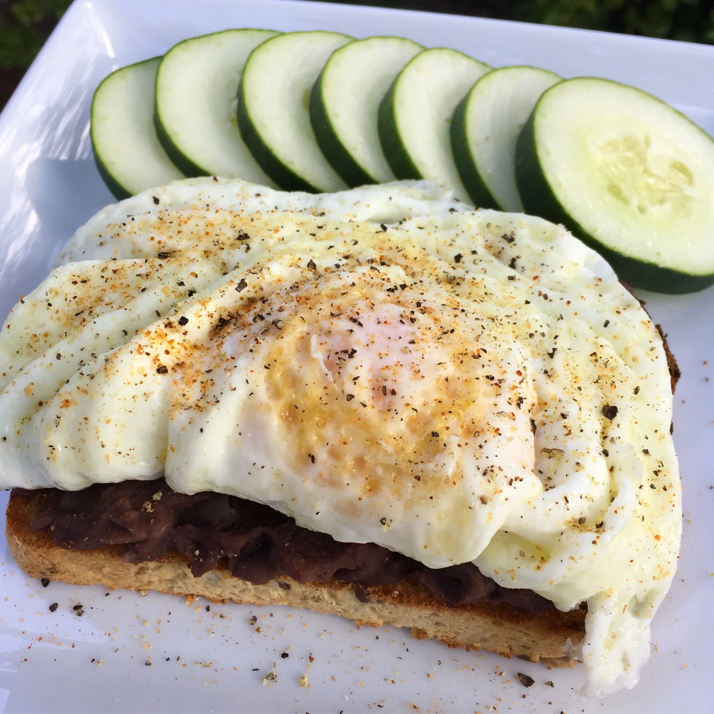 Homemade whole wheat bread + refried black beans + fried egg + extra egg whites + TJ's all purpose seasoning + pepper