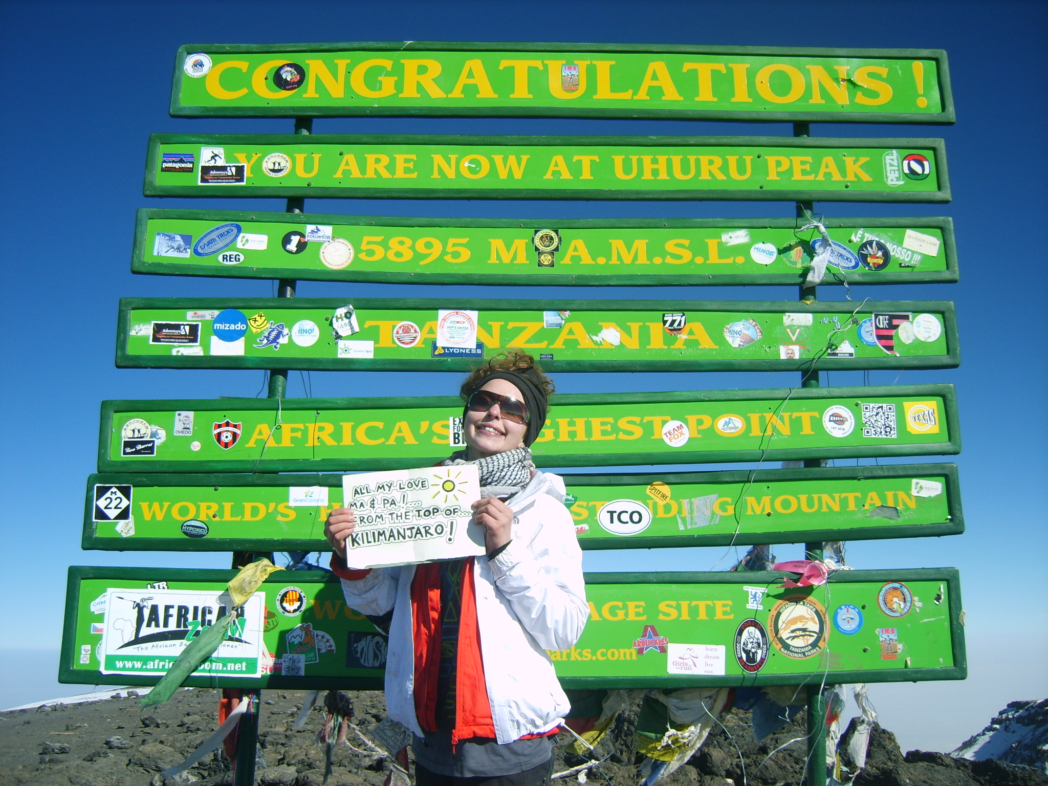 Sarah at the top of Mt. Kilimanjaro with a note to her parents.