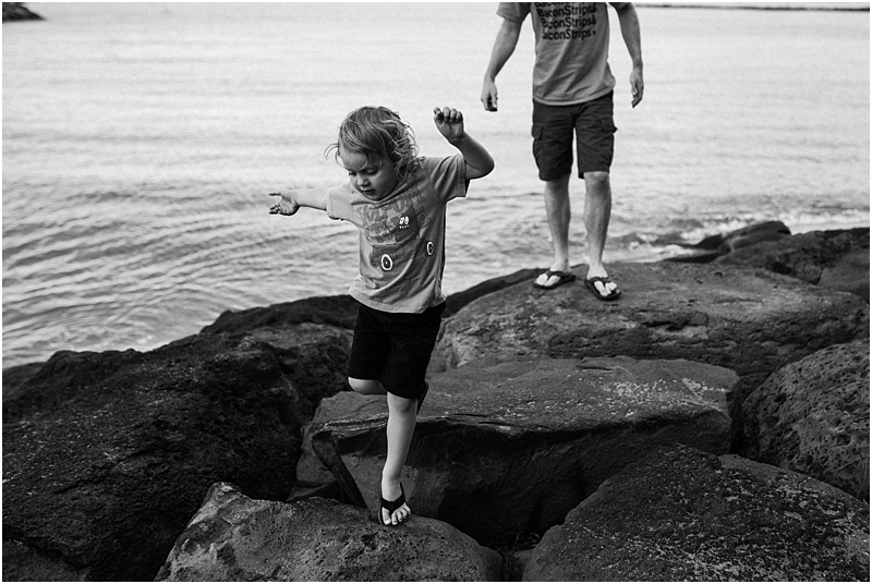 child jumping on rocks at beach lifestyle family photographer
