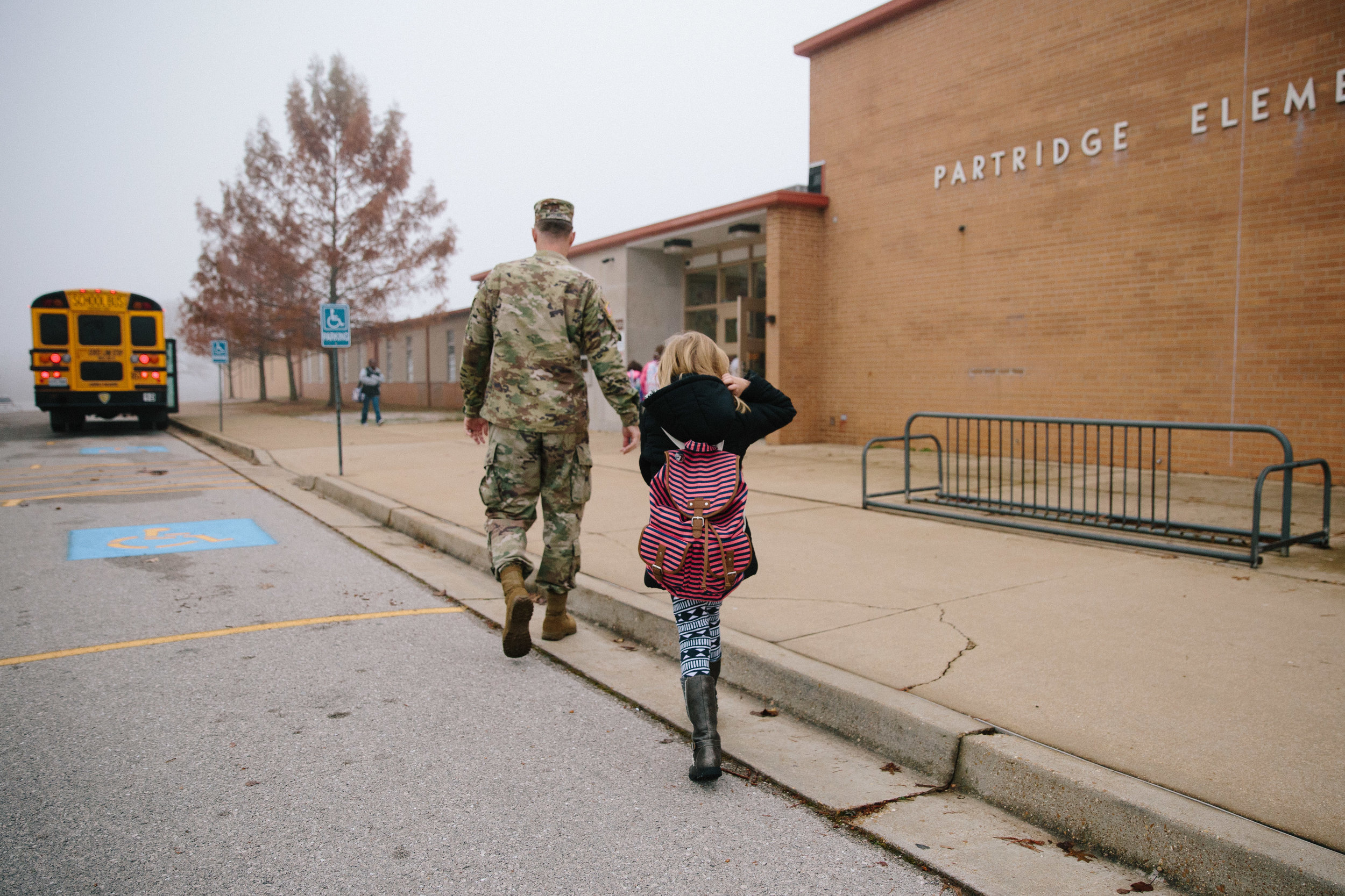 soldier walking daughter to class on first day of school - fort leonard wood documentary photography
