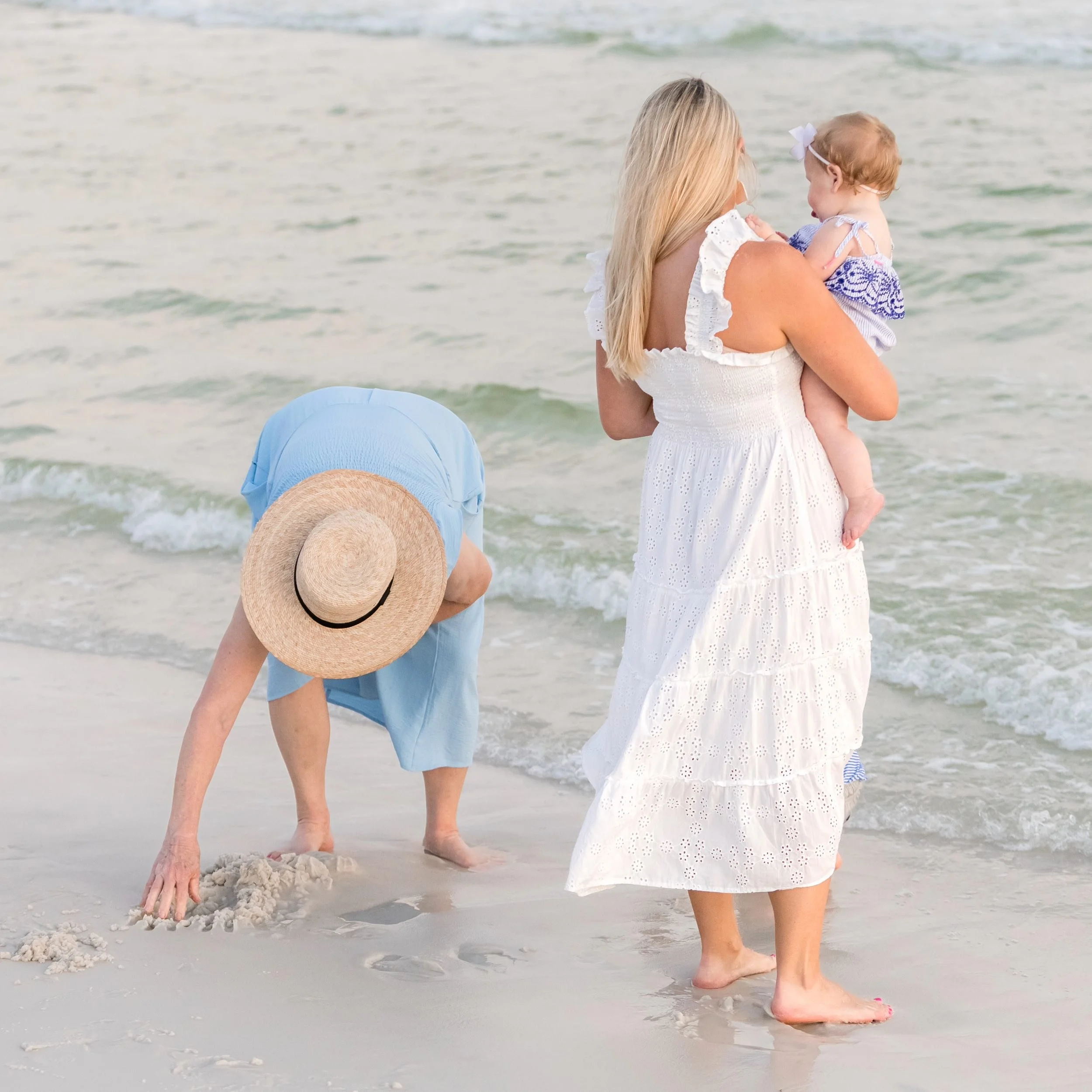 Grandmother, mother and baby on the beach in  Watercolor Florida