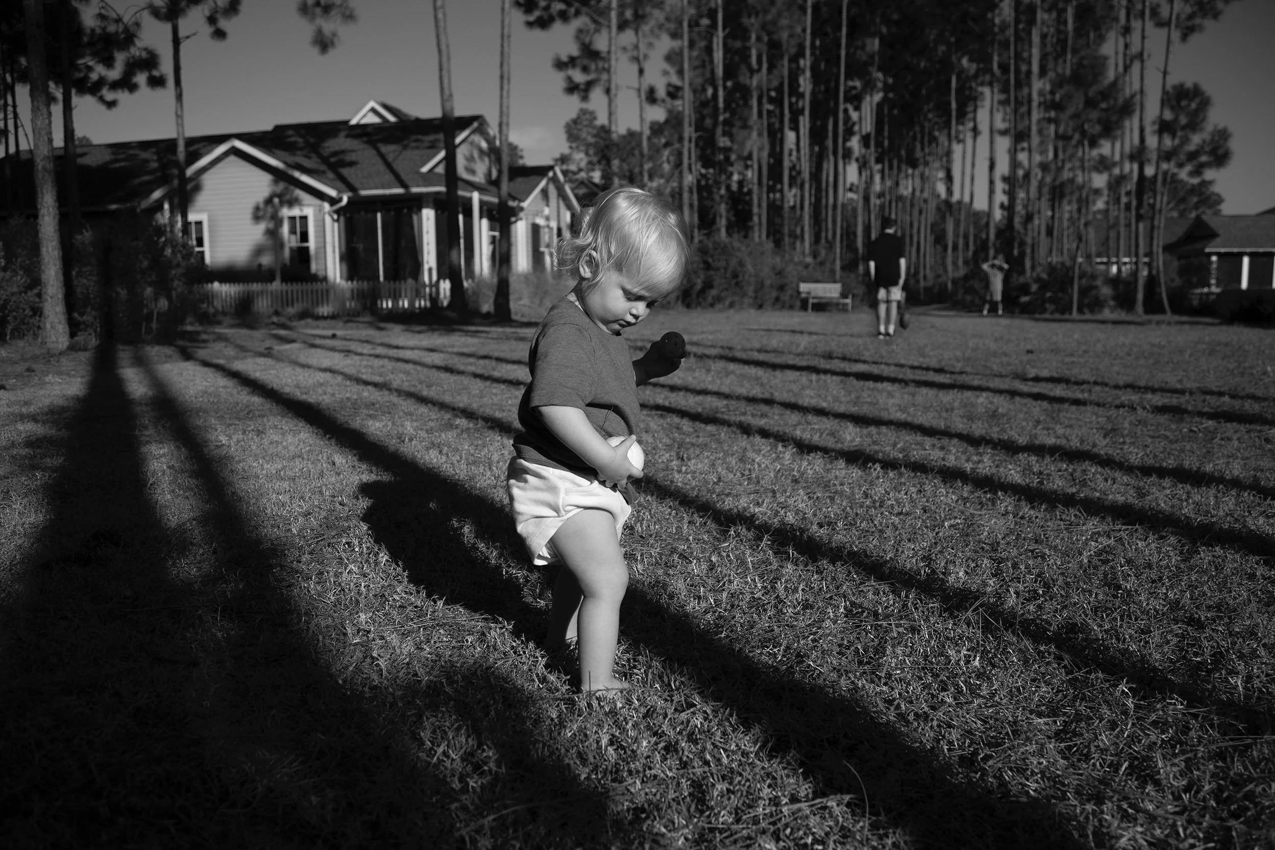 baby playing ball in candid family photography session in watersound origins.
