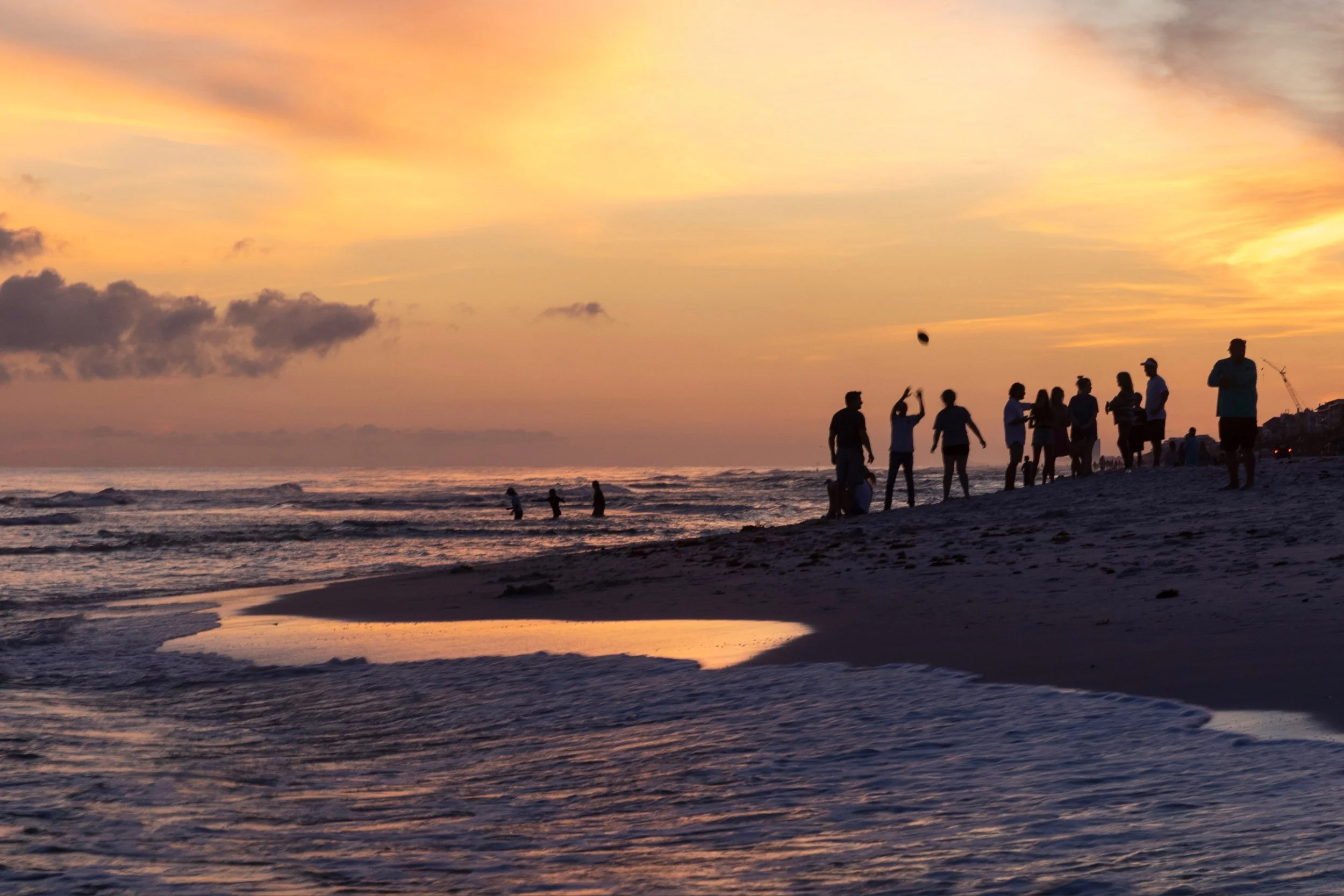 Family watching the sunset on a 30A beach