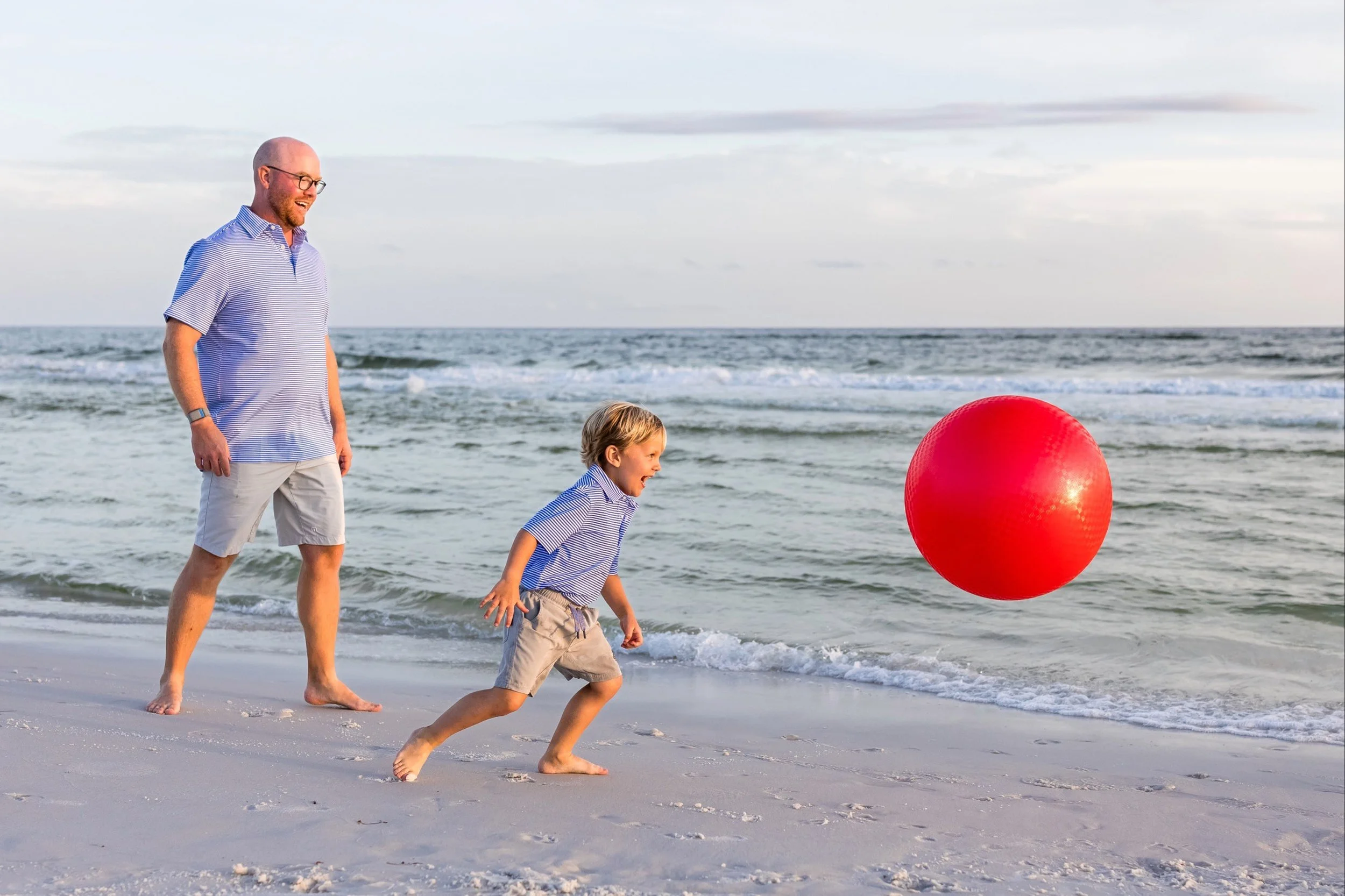 Father and son playing on a 30A beach