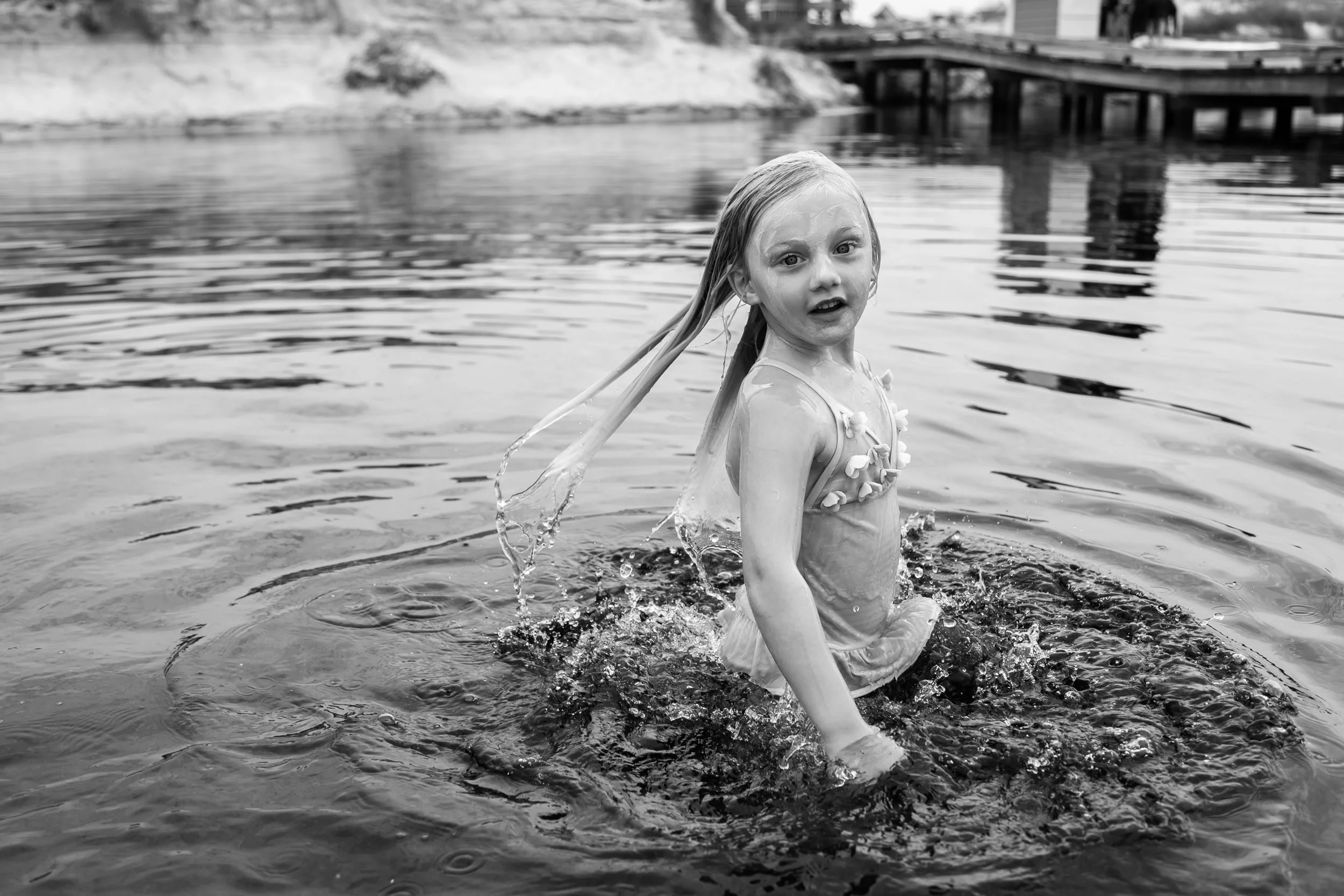 little girl coming out of the dune lake during fmaily photography session in watersound beach on 30A