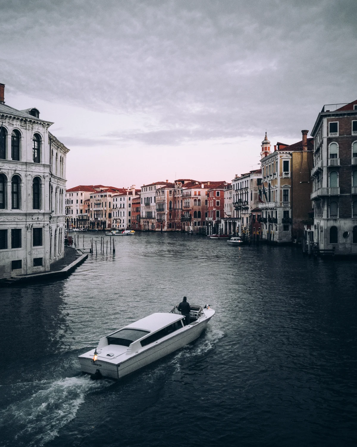 Waiting a few minutes for a boat to enter the frame immensely increased the visual tension in the photograph. Notice how the lighter color of the road and water behind it created a visual line leading the viewer into the image.