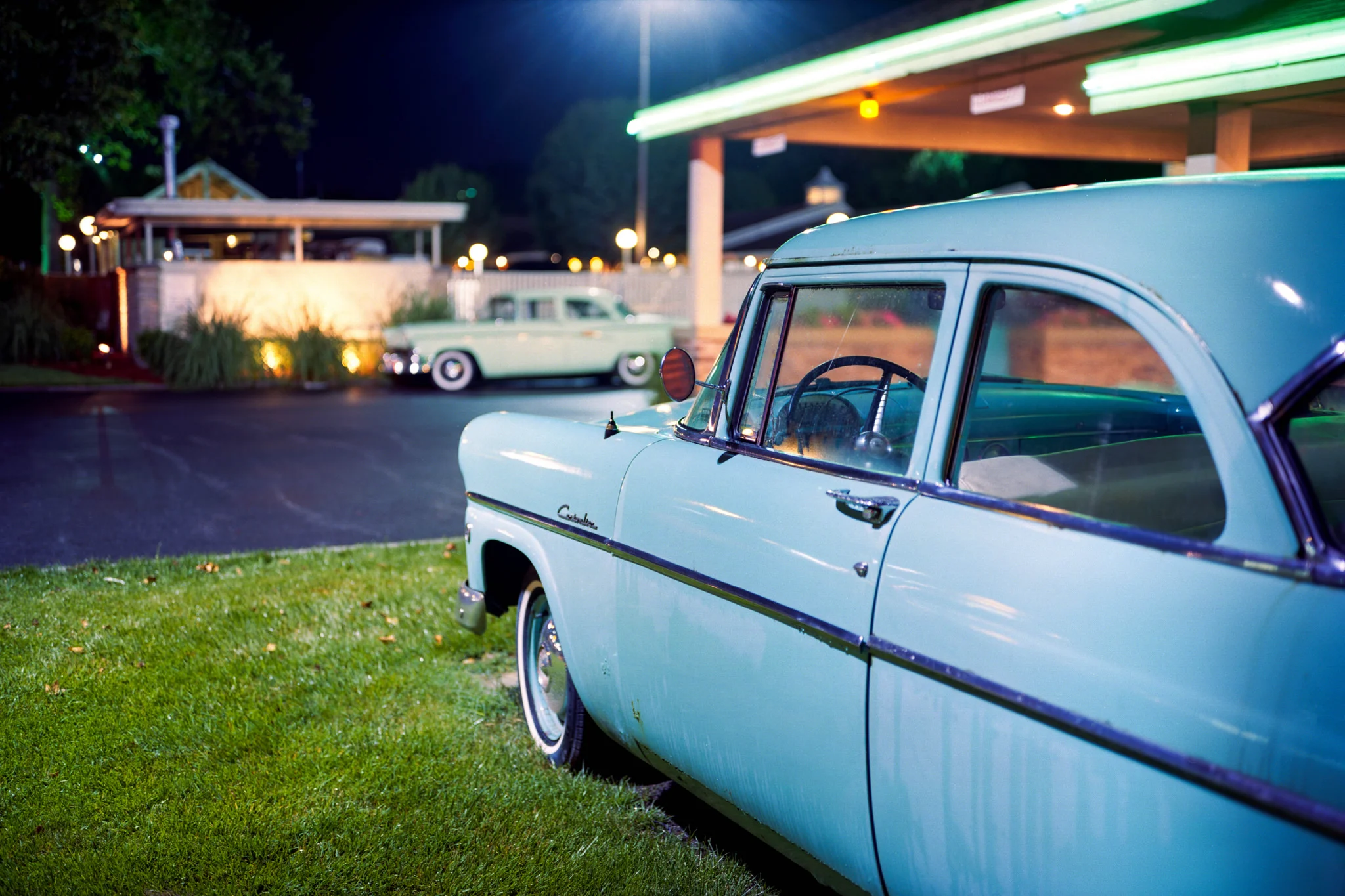 The classic cars stationed out front of the motel.