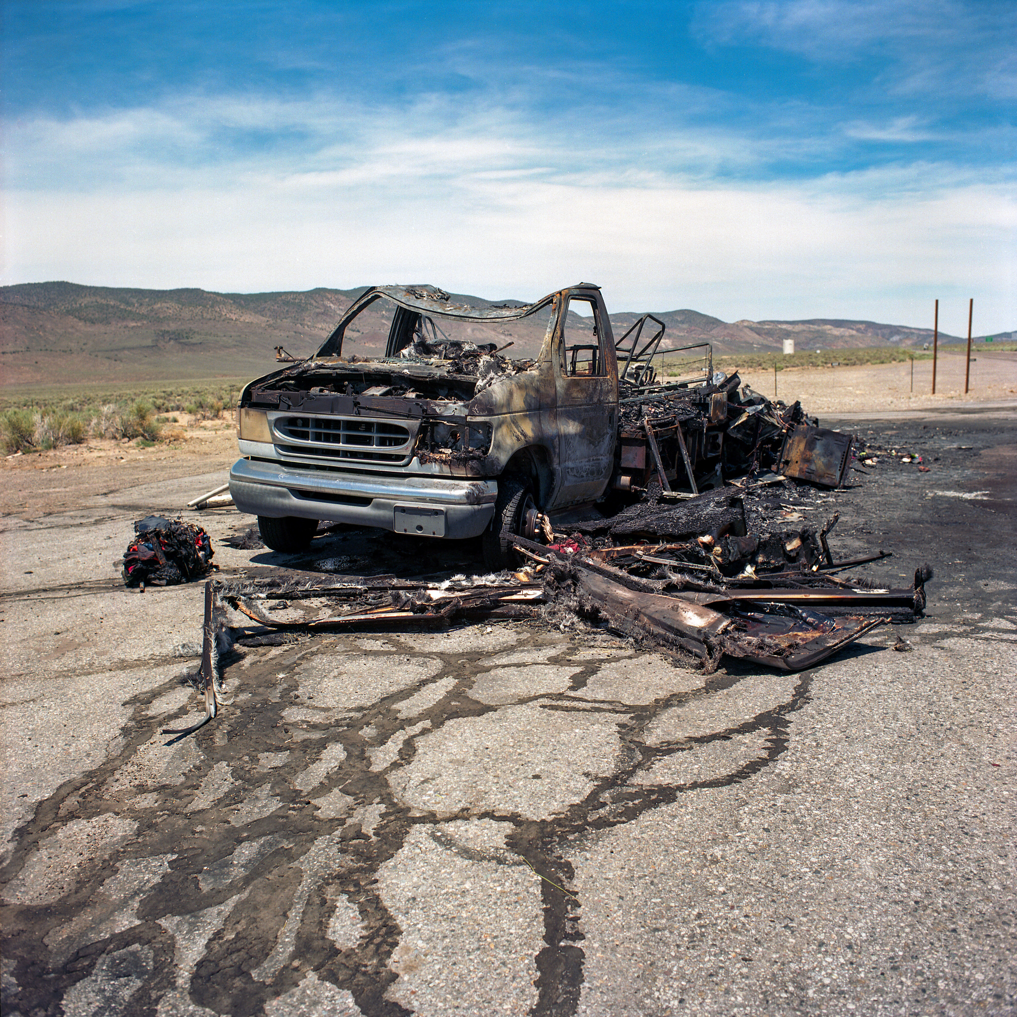 A burnt out van on the highway in Nevada.