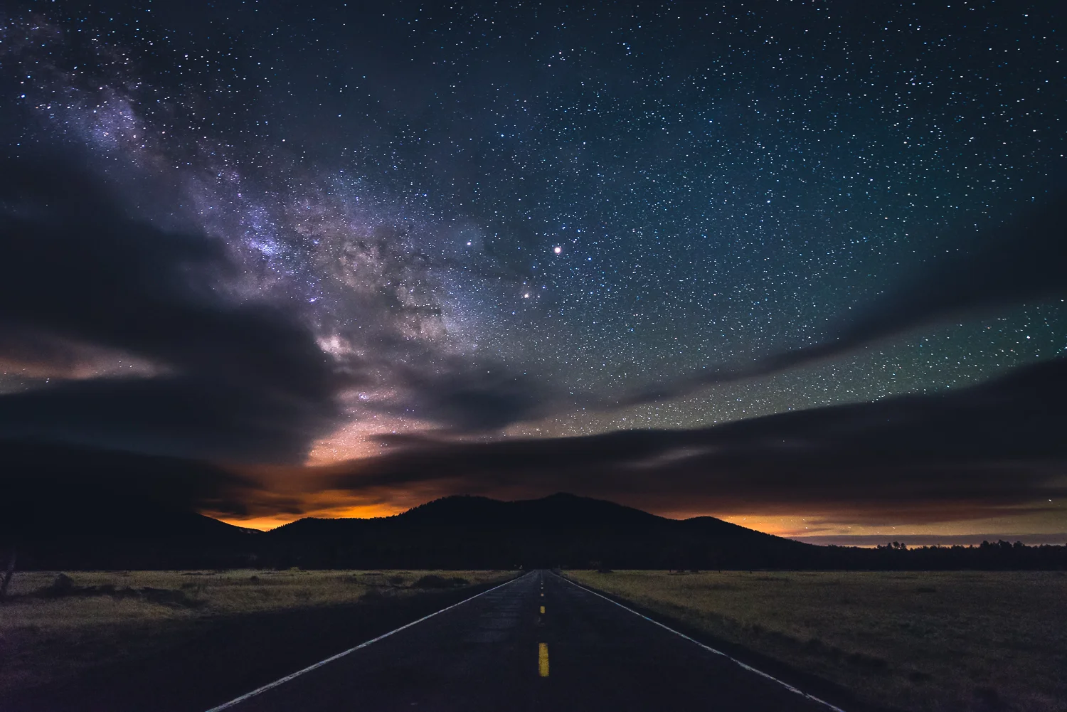 Being out in the middle of night, can be a little bit scary. This night, in particular, i was out solo, 30 miles north of Flagstaff with no sign of life...haha. The solitude, however, allowed me to take this picture right in the middle of the road looking south. Notice Mars shining bright almost directly above the yellow line, and the galactic plane of the Milky Way peaking through on the left
